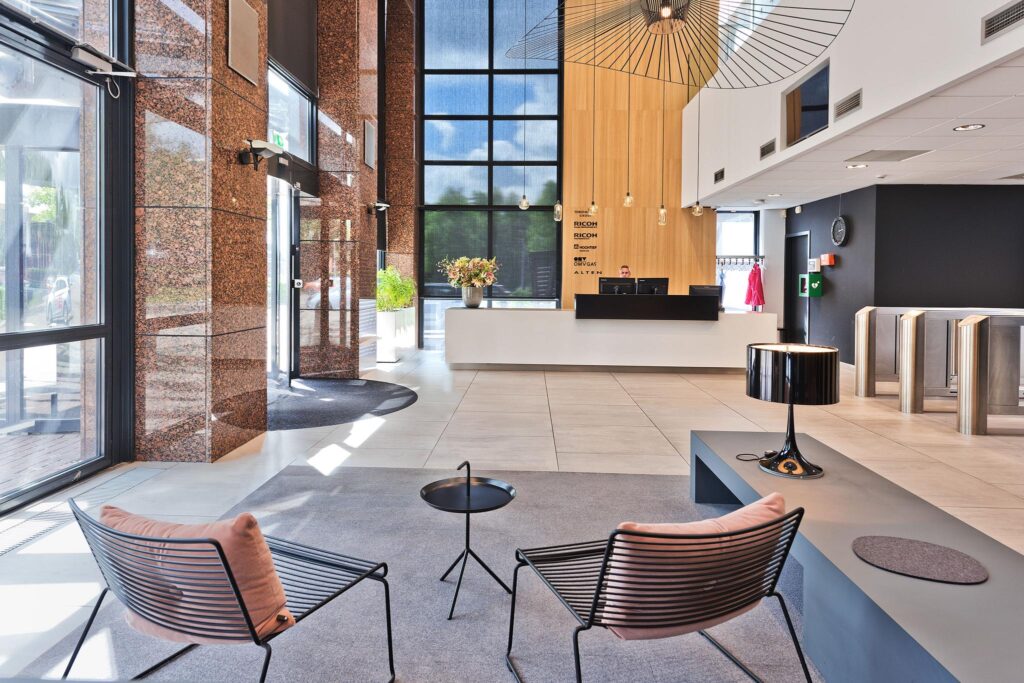 Modern office lobby on Prof. W.H. Keesomlaan with a reception desk, seating area, and large windows.